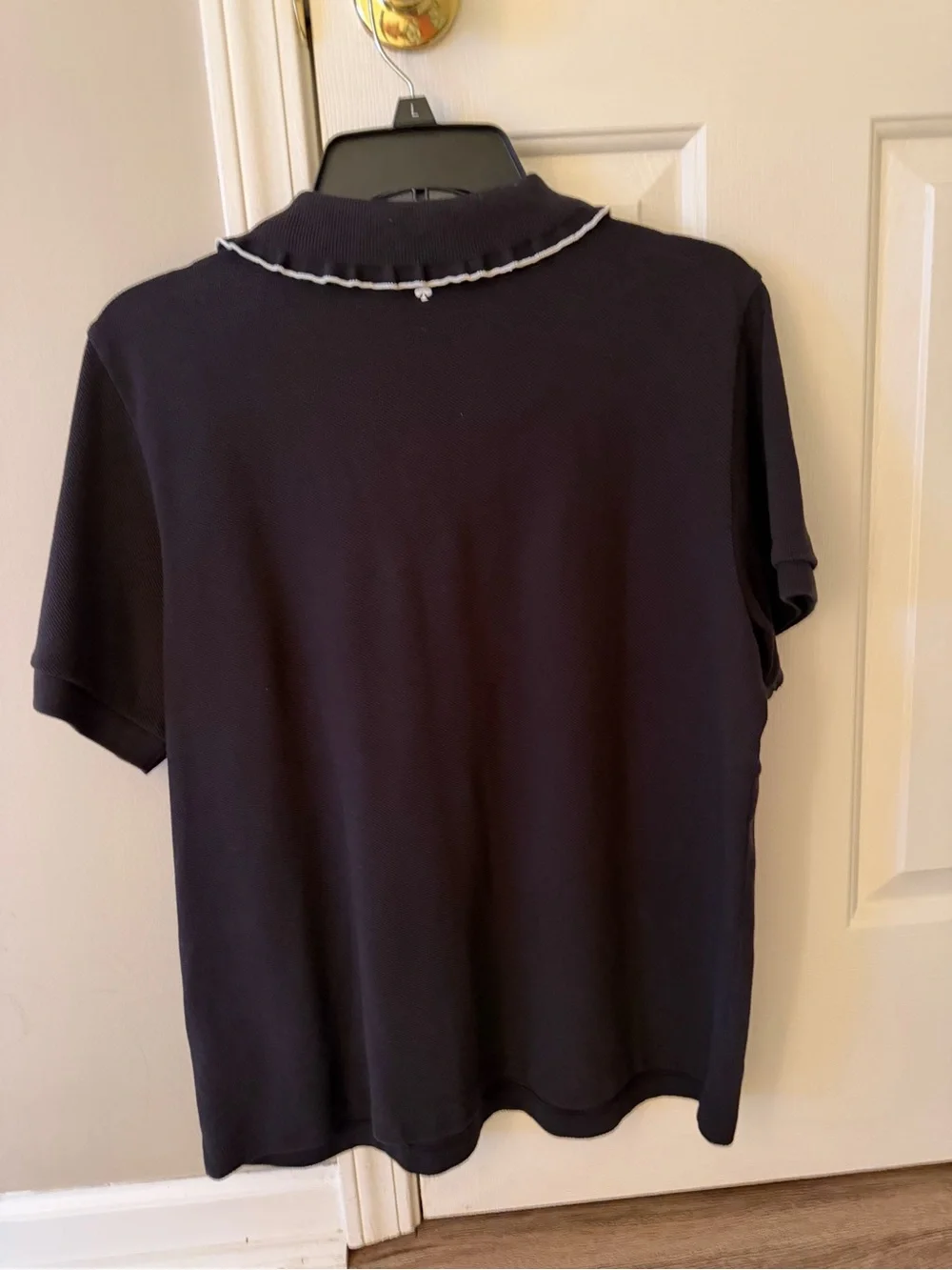 kate spade black polo top with white trim and embroidered logo.